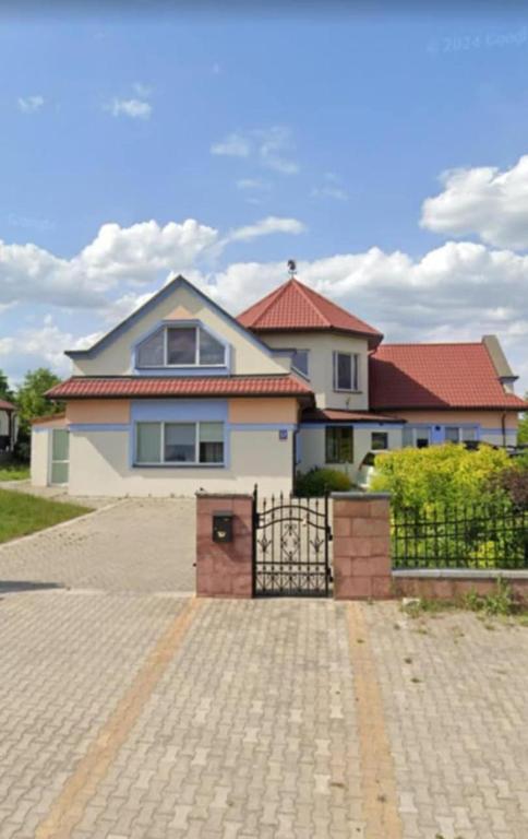 a house with a gate in front of it at Agroturystyka Biełka in Giełczyn