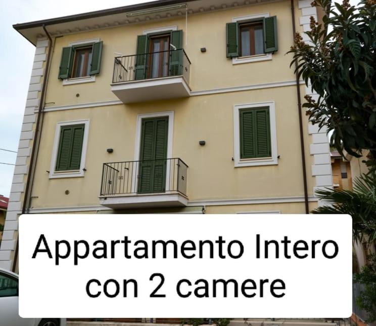 a building with a sign in front of it at QuattroQuattroQuattro in Porto San Giorgio