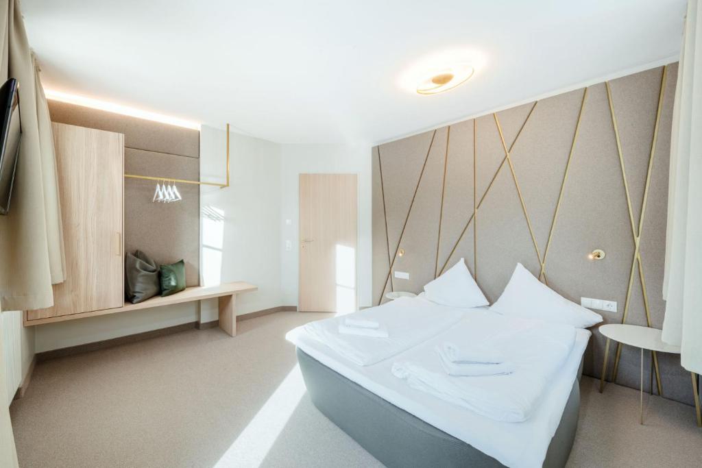 A bed or beds in a room at Crystls Aparthotel
