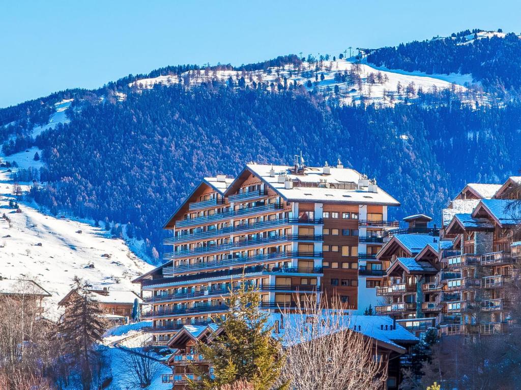 a large building on top of a snowy mountain at Apartment Christiania 2 L1 by Interhome in Nendaz