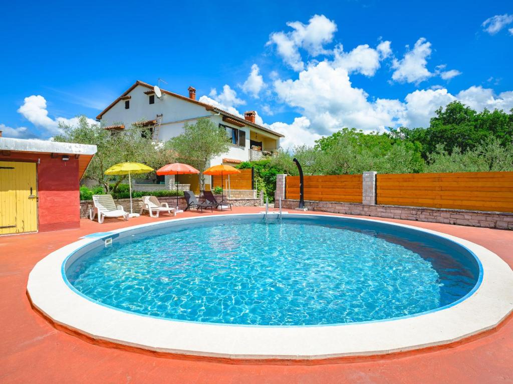 a large swimming pool in the middle of a yard at Apartment Pina by Interhome in Tinjan