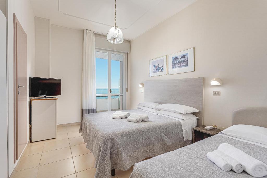 Postel nebo postele na pokoji v ubytování Hotel Caesar
