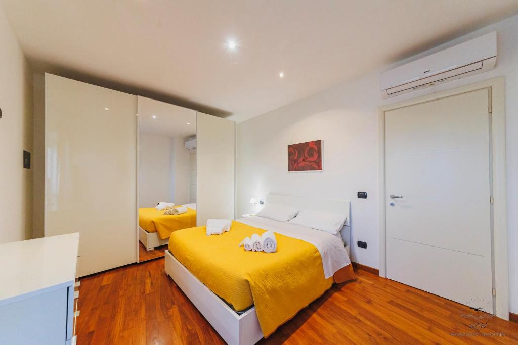 a bedroom with two beds and a mirror at Wow Waterfront Apartment in Bari