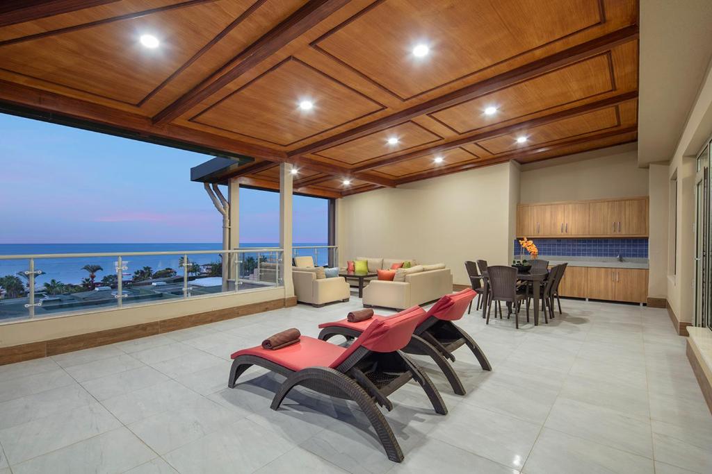 a living room with a view of the ocean at Pine Beach Belek in Belek