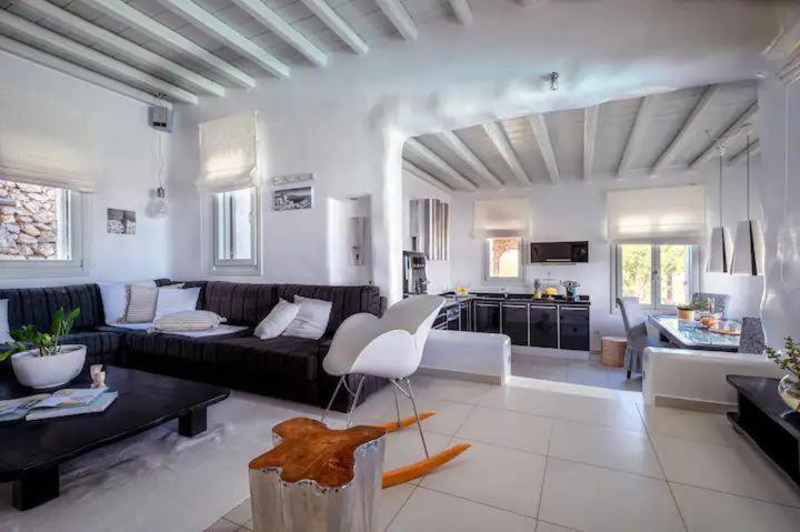 a large living room with a couch and a table at Nimbus My Aktis in Super Paradise Beach
