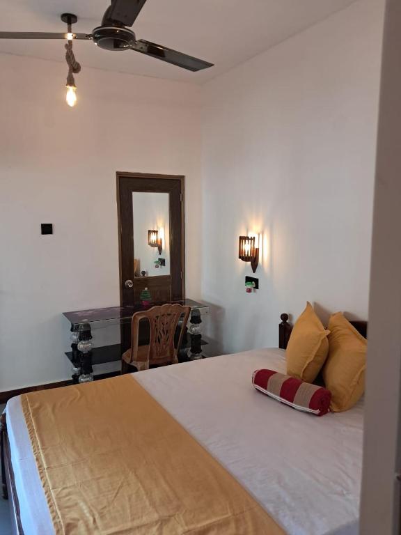 a bedroom with a large bed and a mirror at Sulo House in Weligama