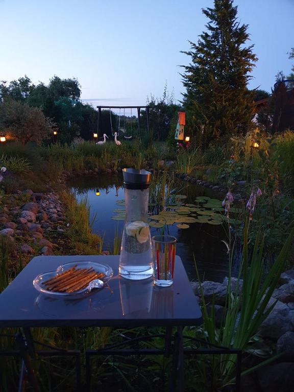 a table with a drink and a bottle and a glass at Ferienwohnung Janine in Neubrandenburg