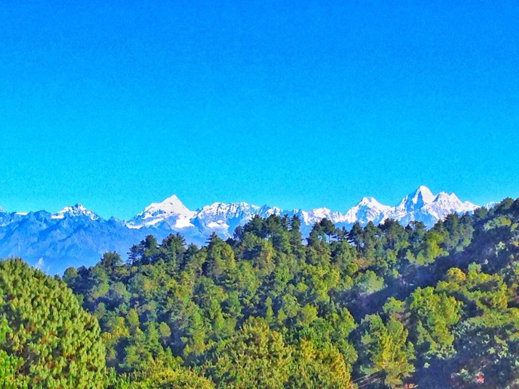 a view of a mountain range with snow capped mountains at Hotel Everest Window View in Nagarkot