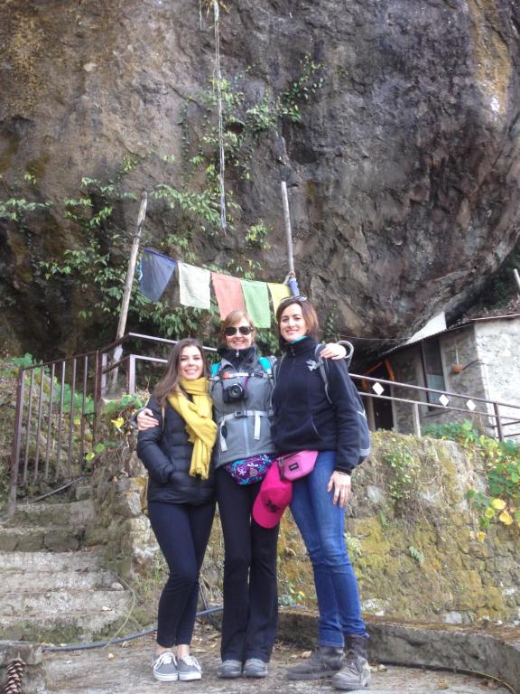 three women posing for a picture in front of a mountain at Hotel Everest Window View in Nagarkot