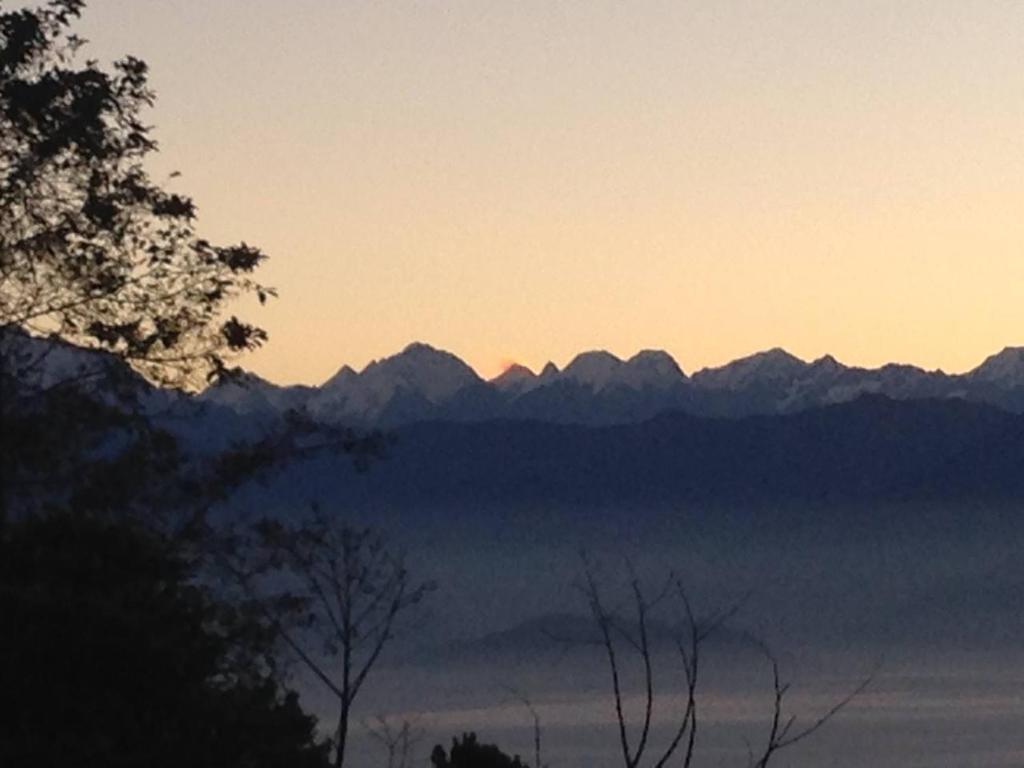 a view of a mountain range at sunset at Hotel Everest Window View in Nagarkot