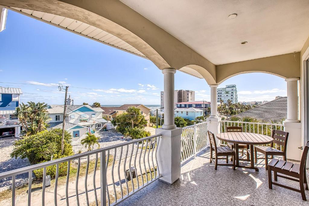 a balcony with a table and chairs and a view of the ocean at Oceanview Family & Pet-Friendly Escape, 300 Steps to Beach, 2608H in New Smyrna Beach