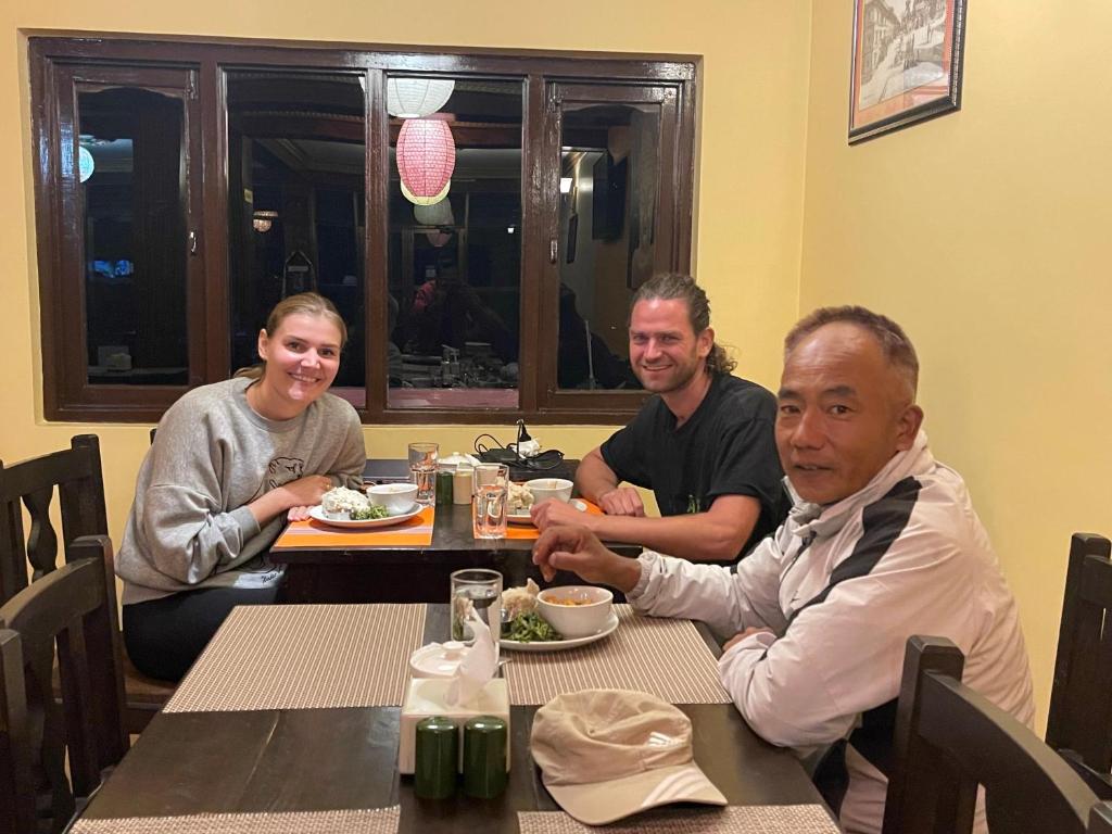 a group of people sitting at a table eating food at Hotel Everest Window View in Nagarkot