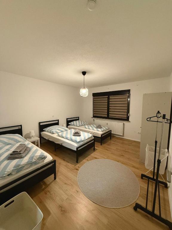 a room with two beds and a rug at MA Apartments - Free Parking, Free WiFi, Relax & Coffee, in Duisburg
