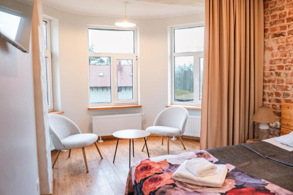 Postel nebo postele na pokoji v ubytování Kaķītis hotel & spa