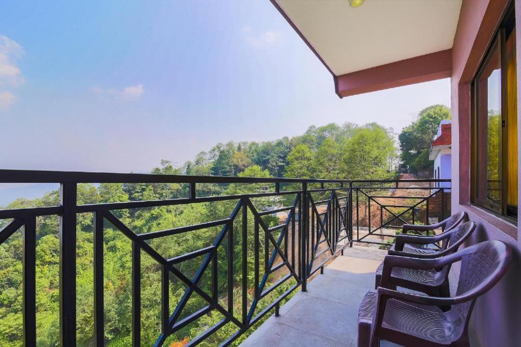 a balcony with chairs and a view of the mountains at Hotel Everest Window View in Nagarkot