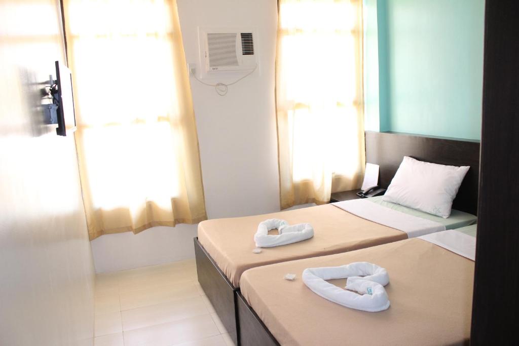 Postel nebo postele na pokoji v ubytování Coron Visitors Hotel