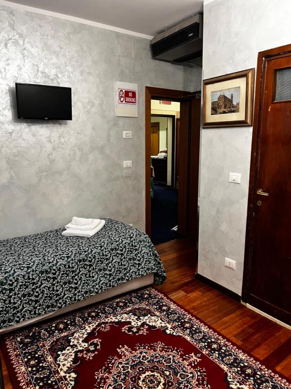 Llit o llits en una habitació de Hotel Malibran
