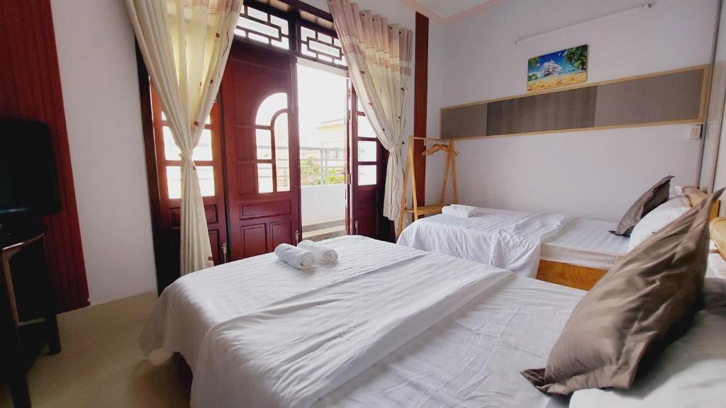 Postel nebo postele na pokoji v ubytování Mekong INN