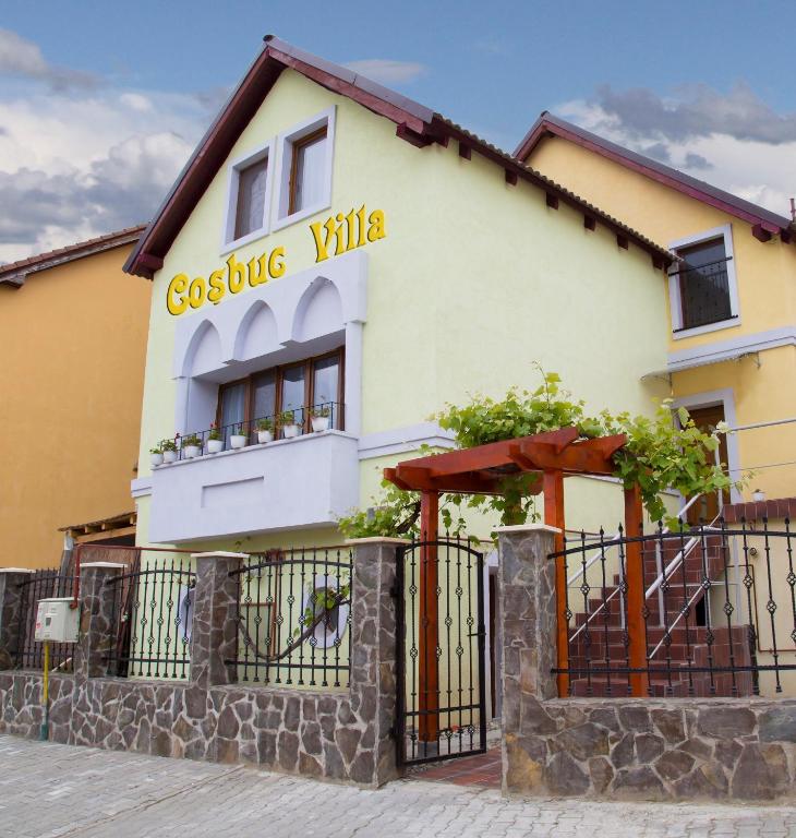 a building with a sign that reads geelong villas at Cosbuc Residence & Villa in Sighişoara