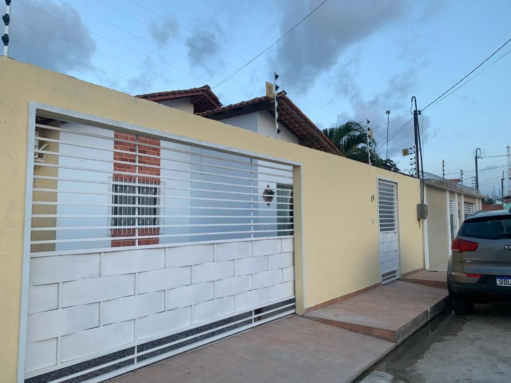 a garage with two garage doors and a car parked at Bragança -Pa linda casa completa in Bragança