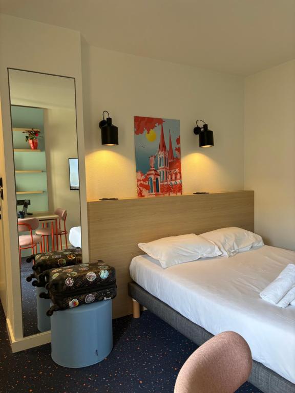 Postel nebo postele na pokoji v ubytování Appart'Hôtel Lauréades Clermont-Ferrand Centre Jaude