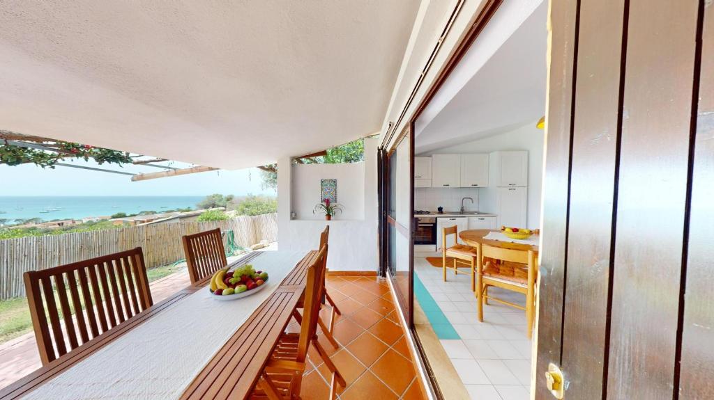 a kitchen and dining room with a view of the ocean at Villa Marina in Campu Longu