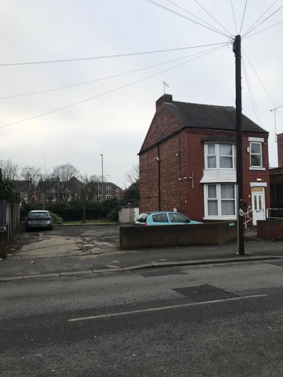 a red brick house with a car parked in front of it at Contractor House with parking in Worksop
