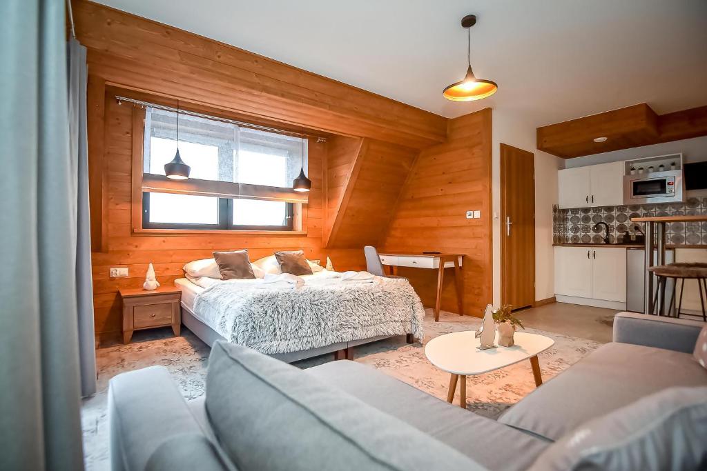 Posteľ alebo postele v izbe v ubytovaní Apartamenty Pod Tatrzańskim Niebem
