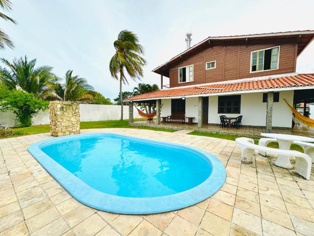 a swimming pool in front of a house at Casa Bela Araçagy, 400m da praia. in São-José-do-Ribamar