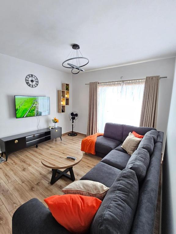 a living room with a couch and a television at orana homes II in Ruiru