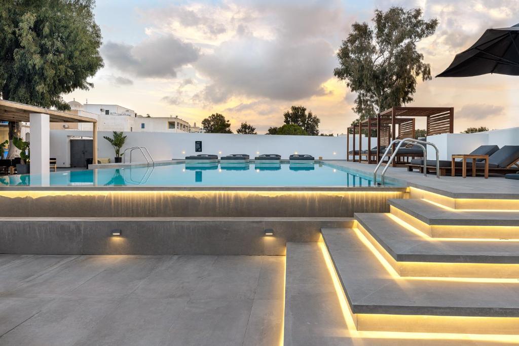 a swimming pool with lights in a house at Kalisti Hotel & Suites in Fira