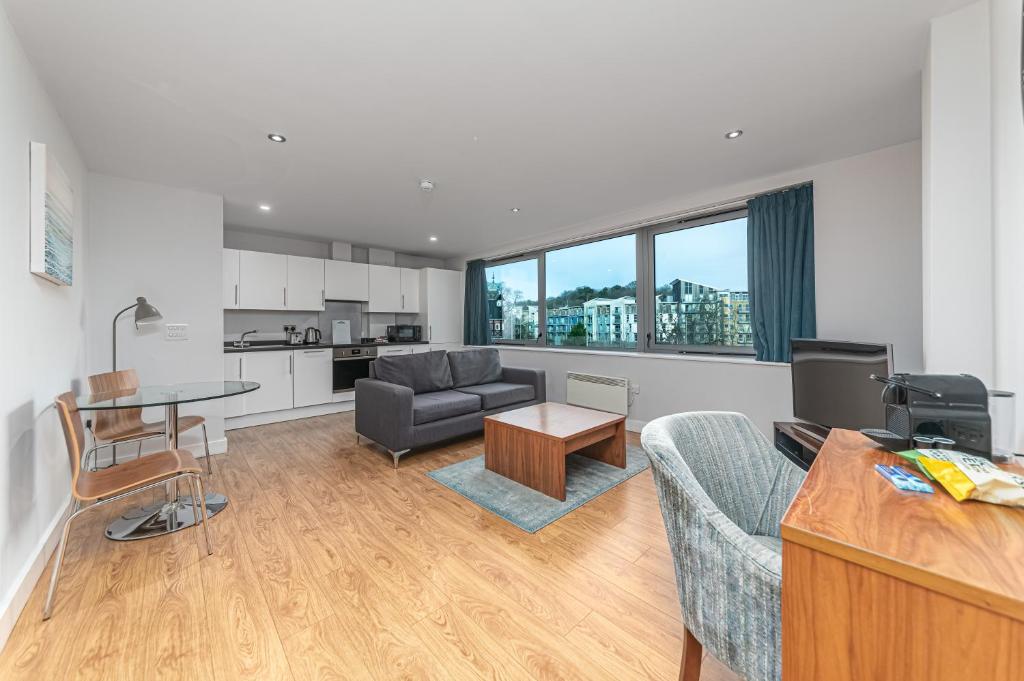 a living room with a couch and a table at HQ Aparthotel Farnborough in Farnborough