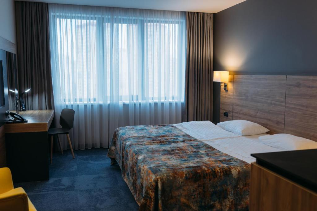 Postel nebo postele na pokoji v ubytování Favor Park Hotel