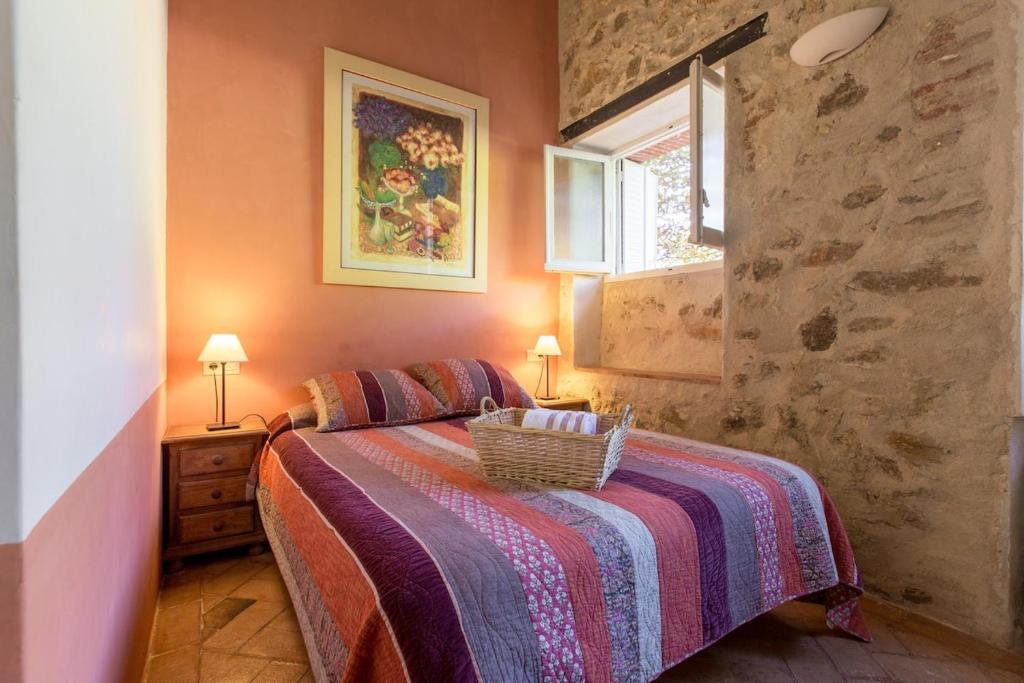 a bedroom with a bed with a basket on it at Villa Carmen del Rosal in Miraflores de la Sierra
