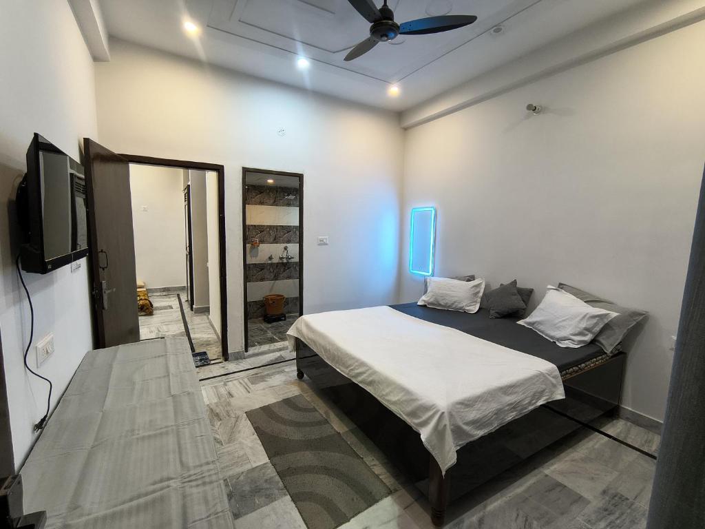 a bedroom with a bed and a ceiling fan at Siddhi Homestay in Varanasi