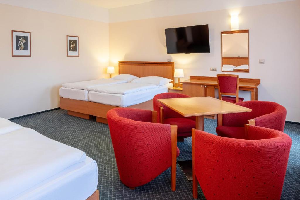 Postel nebo postele na pokoji v ubytování Hotel Slovan