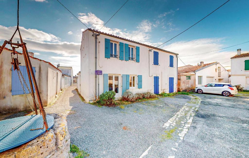 a car parked in a parking lot next to a building at Gorgeous Home In Saint-Denis-D'oléron in Saint-Denis-dʼOléron