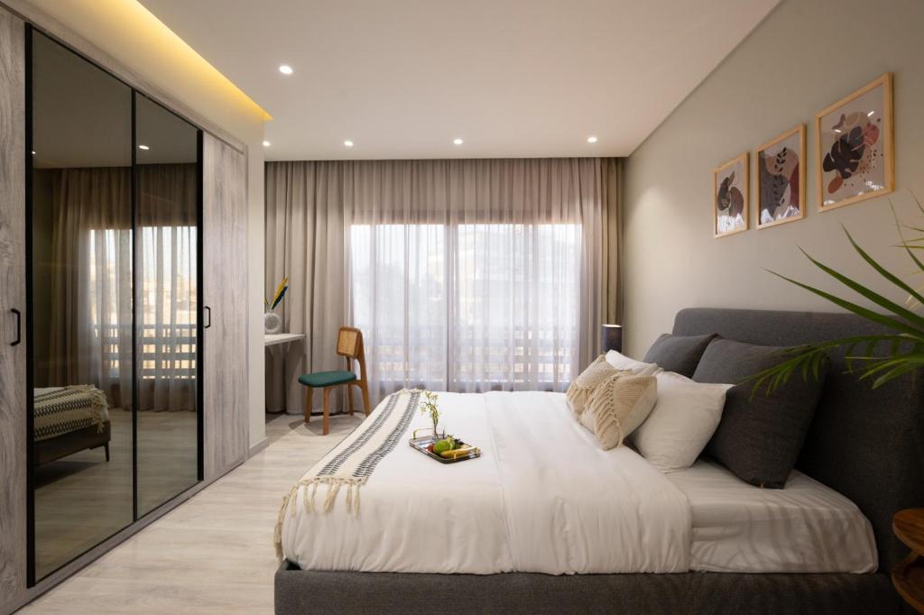 a bedroom with a large bed and a couch at Degla by Spacey # 39 - Studio in Maadi in Cairo