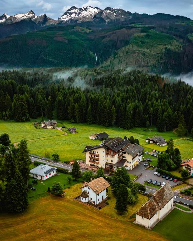 an aerial view of a resort in the mountains at Phi Hotel Bellamonte in Predazzo