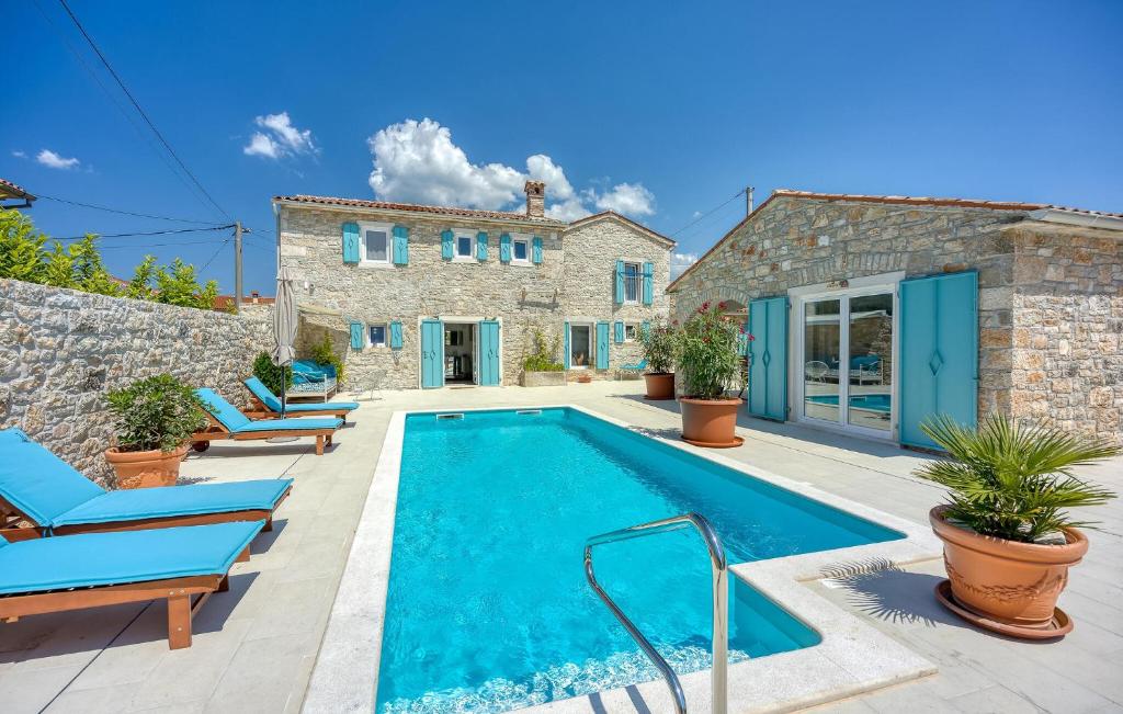 a villa with a swimming pool and a house at Lovely Home In Selina in Selina