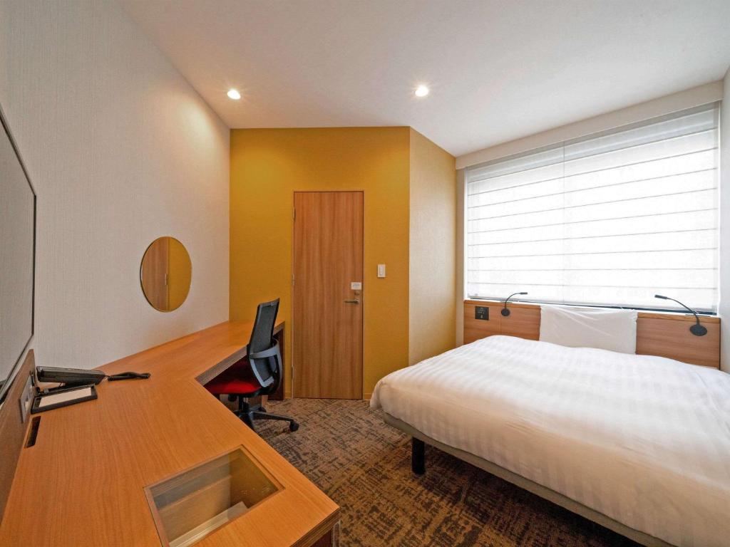 Postel nebo postele na pokoji v ubytování Comfort Inn Fukuoka Tenjin