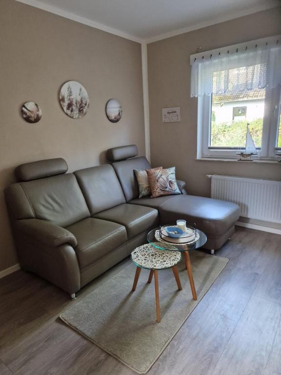a living room with a couch and a table at Seekiste in Schleswig