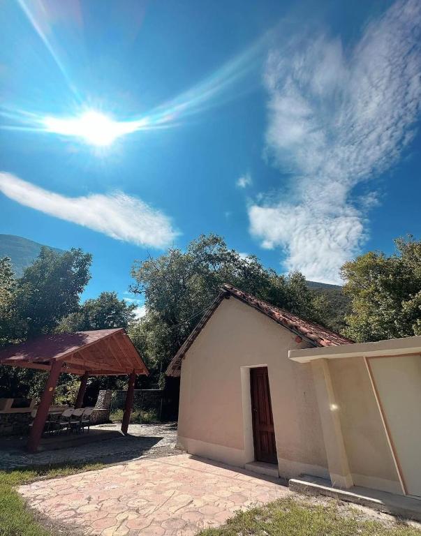 a building with a picnic table and the sun in the sky at ESTANCIA CASA DE PIEDRA casa 2 in San Isidro