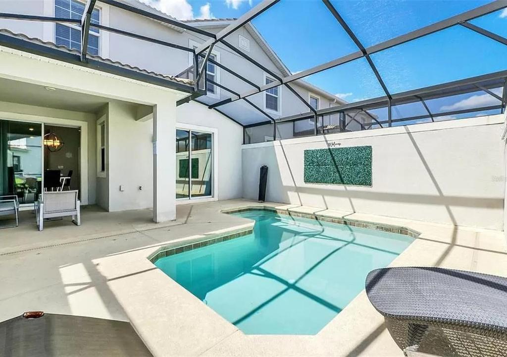 a swimming pool in a house with a glass ceiling at 1569 SD - Spacious Champions Gate Retreat with Modern Amenities in Davenport