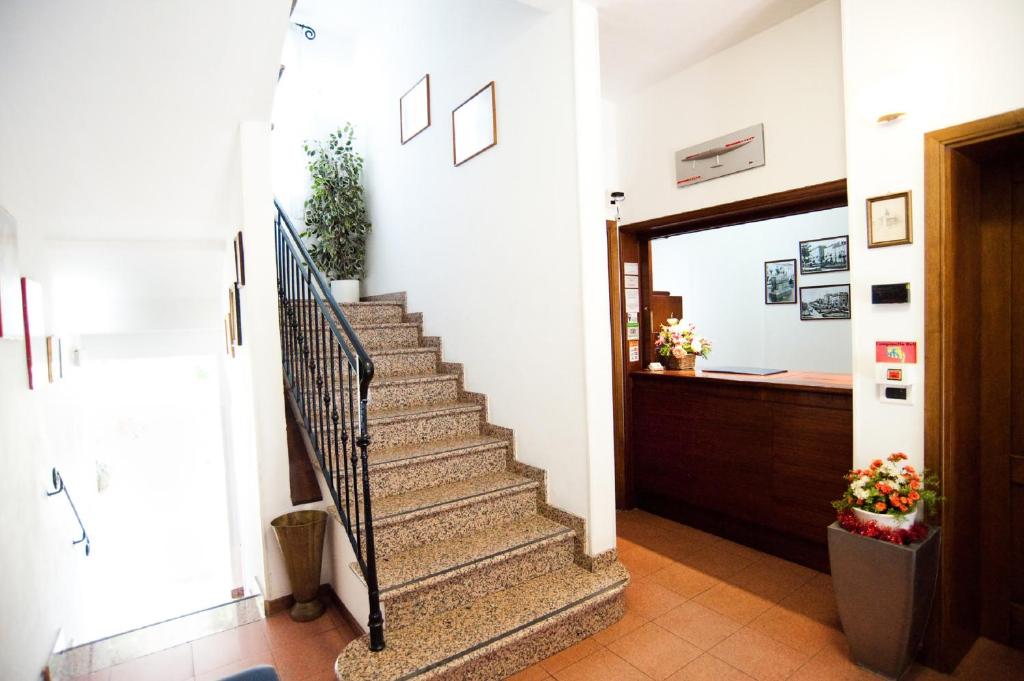 a hallway with stairs leading up to a staircase at Hotel La Toscana in Arezzo