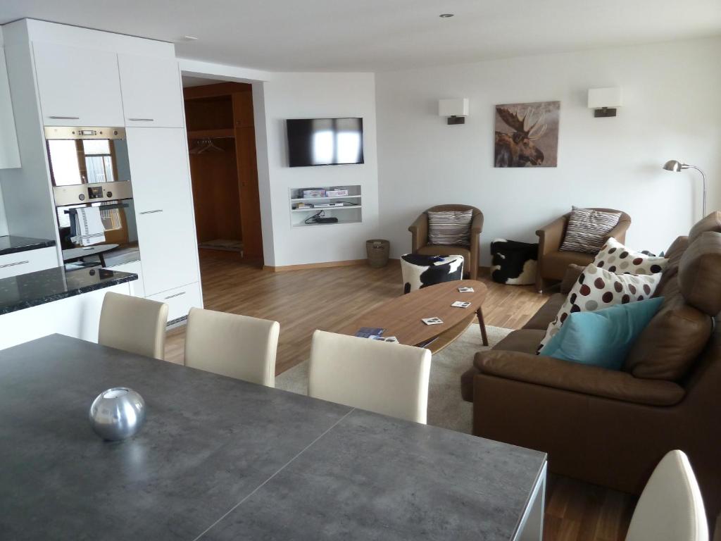 uma sala de estar com uma mesa e um sofá em Chalet Mittaghorn em Adelboden
