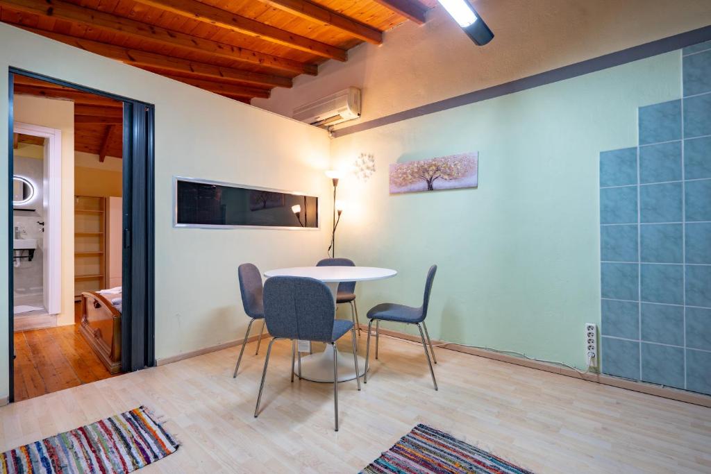 a dining room with a table and chairs at Monastiraki metro st 1 bedroom apt for 2 by MPS in Athens