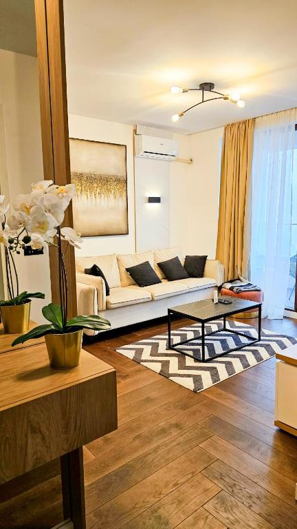 a living room with a couch and a table at Zlatibor Wayout, Spa & Wellness in Zlatibor
