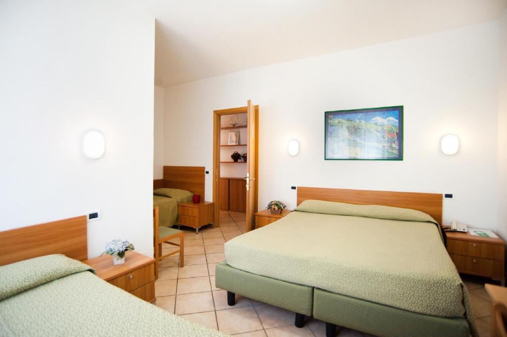 Postel nebo postele na pokoji v ubytování Hotel La Toscana