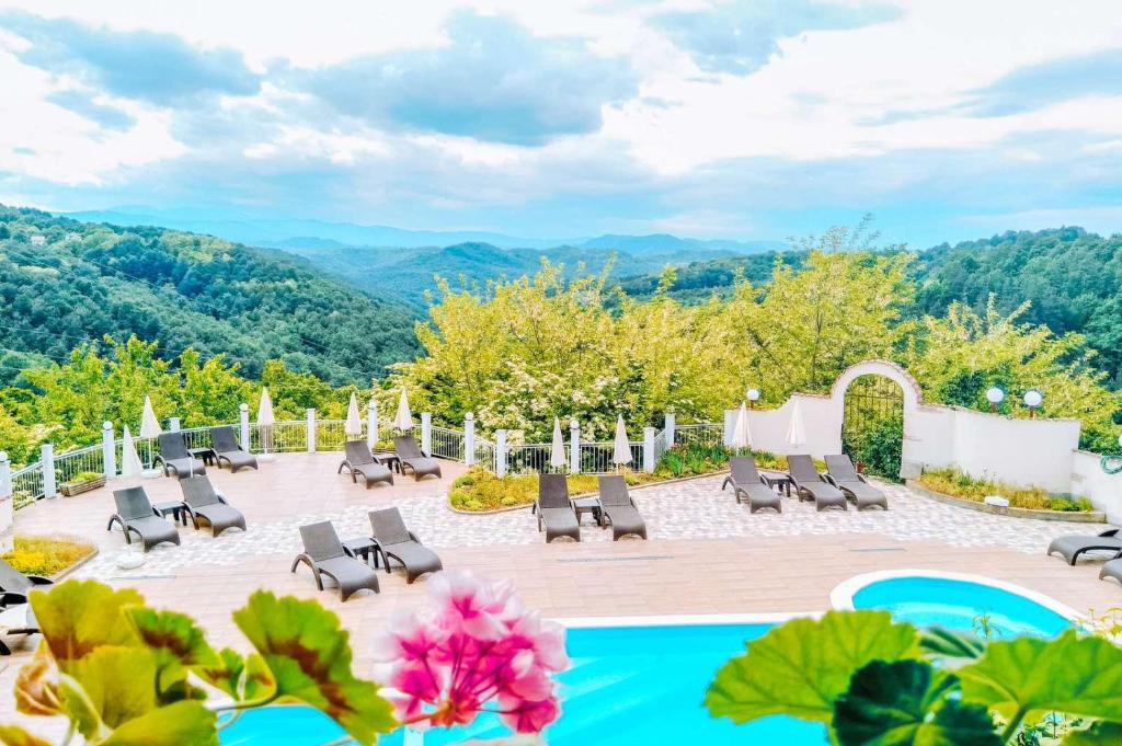 a view of a patio with chairs and a pool at Семеен хотел Балани in Gabrovo